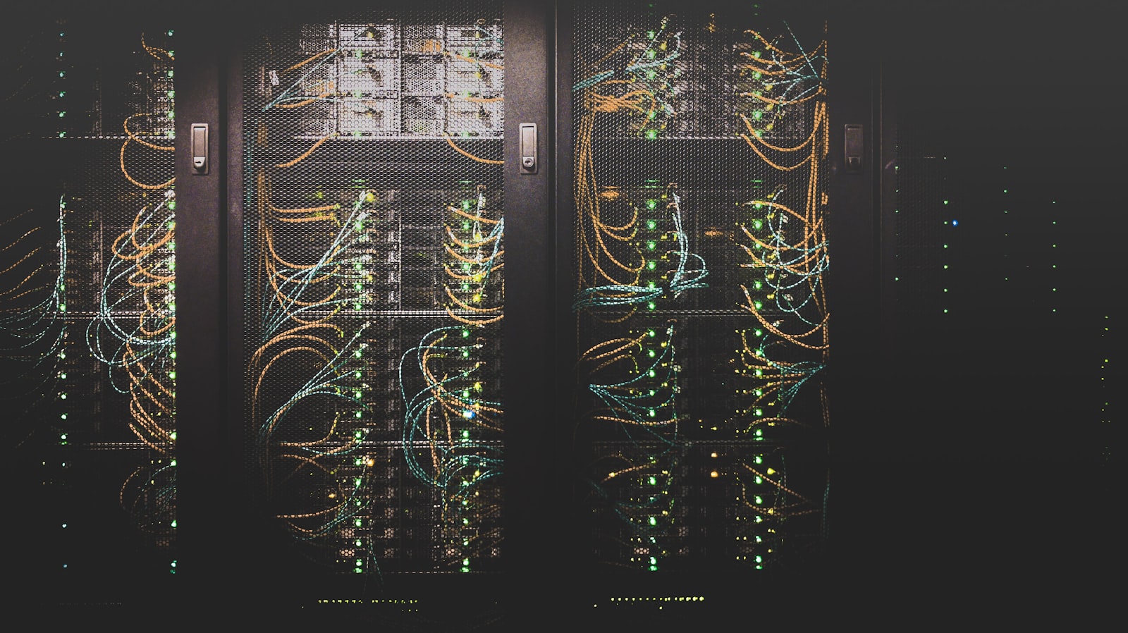 Network racks glowing softly in a dark equipment room