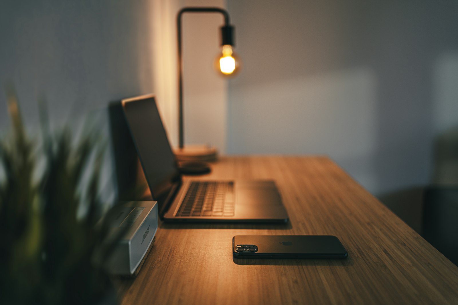 Executive desk lit by a single warm lamp after hours